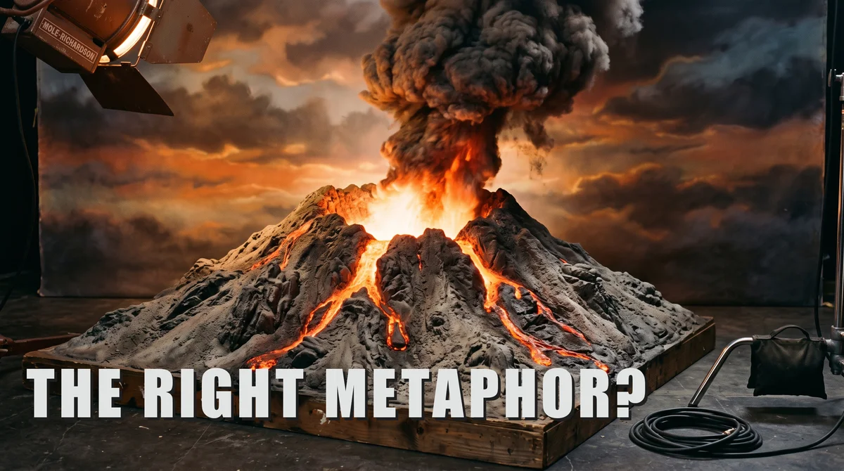 Model volcano erupting with glowing lava on a film soundstage, studio lamp and cables visible. Text: "THE RIGHT METAPHOR?"